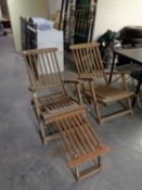 A pair of teak reclining steamer chairs with footstool.
