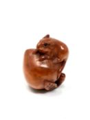 A carved Chinese hardwood netsuke - Rat standing on a peach