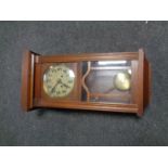 An Edwardian oak wall clock