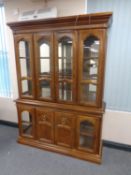 A colonial style glazed bookcase with mirrored back