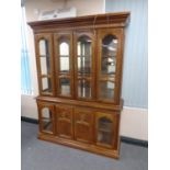A colonial style glazed bookcase with mirrored back