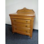 A contemporary light oak three drawer chest