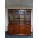A reproduction antique style four door bookcase