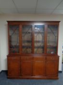 A reproduction antique style four door bookcase