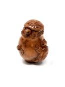 A carved Chinese hardwood netsuke - Turtle family in pot