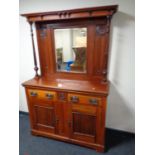 A late Victorian stained beechwood mirrored back sideboard