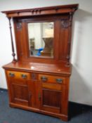 A late Victorian stained beechwood mirrored back sideboard