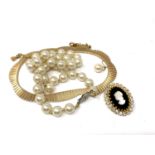 A flat link gold plated necklace together with costume pearls,