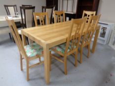 A contemporary pine effect dining table together with a set of six chairs