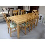 A contemporary pine effect dining table together with a set of six chairs