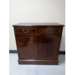 A reproduction inlaid mahogany double door cabinet together with a single drawer side cabinet