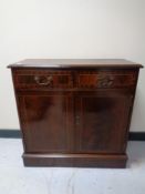 A reproduction inlaid mahogany double door cabinet together with a single drawer side cabinet