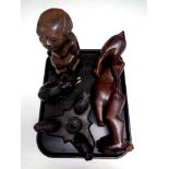 A tray containing two African carved figures,