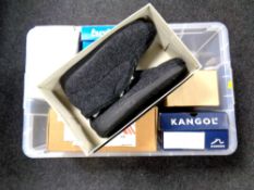 A plastic crate containing a quantity of boxed shoes,