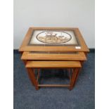 A nest of three 20th century Mobel Fabrikken Danish teak tile topped tables