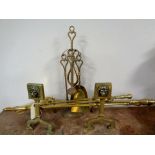 A pair of antique brass fire dogs together with three companion pieces,