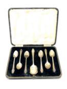 A set of six silver teaspoons and scoop in case,