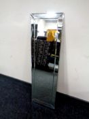 A small rectangular frameless mirror