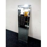 A small rectangular frameless mirror