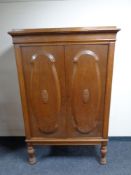 An early 20th century continental oak double door cabinet on turned legs