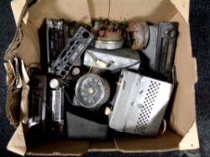 A box of vintage car radios and speedometers