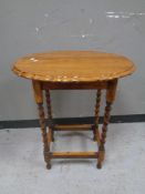 An Edwardian oak barley twist occasional table