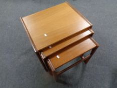 A nest of three teak tables