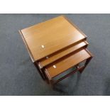 A nest of three teak tables