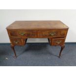 A walnut dressing table on cabriole legs