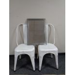 Two painted metal chairs together with a metal framed mirror