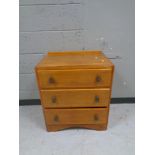 A 1930s oak three drawer chest