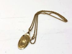 A gold plated religious pendant on chain