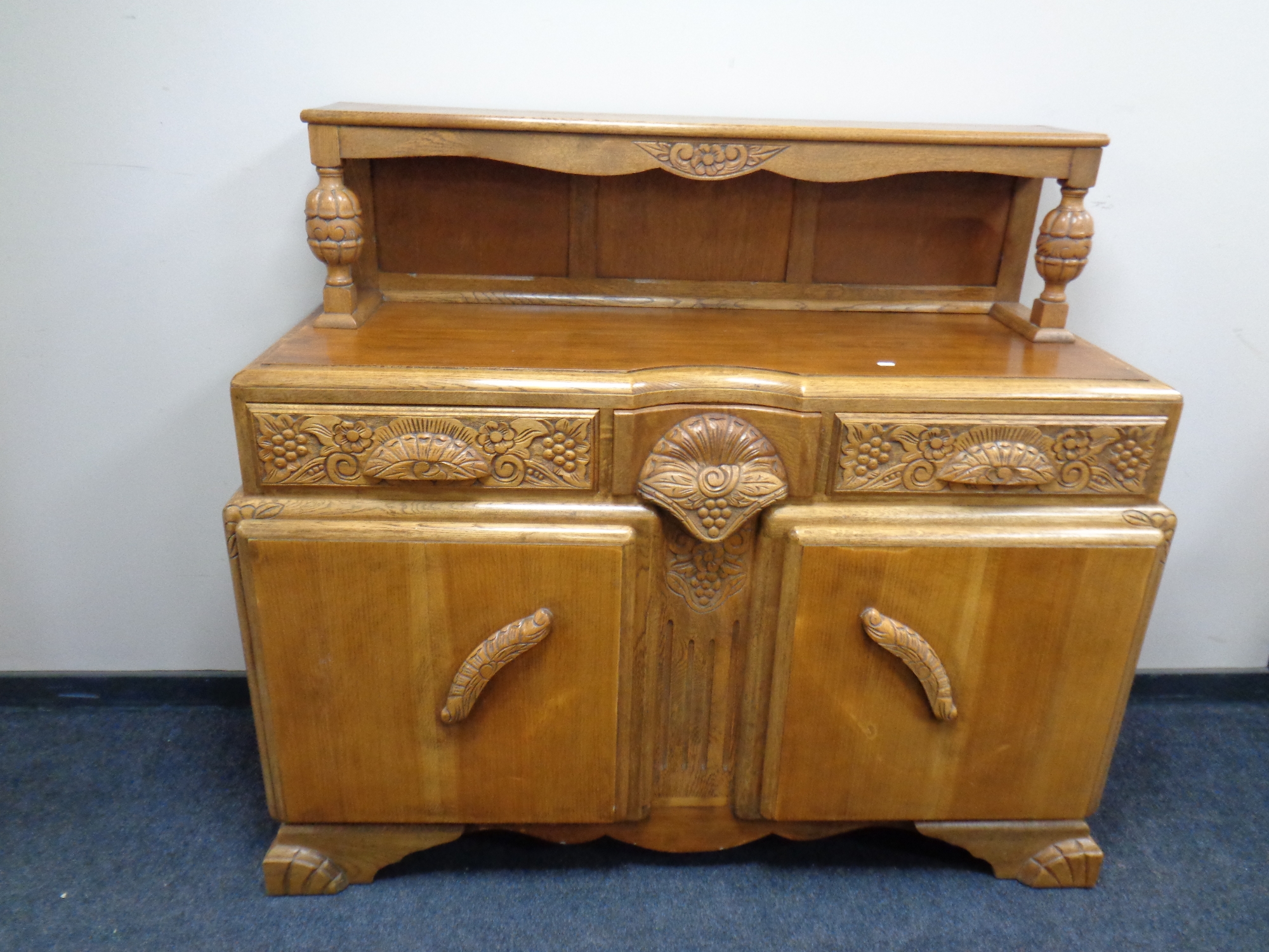 A 1930s heavily carved oak buffet sideboard together with matching pull out dining table and set of - Image 3 of 3