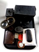 A tray containing Ingersol pocket watch, vintage spectacles, cased opera glasses, Polaroid camera,