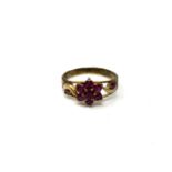 A ruby cluster ring on yellow metal shank,