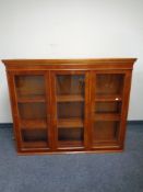 A reproduction glazed yew wood bookcase top