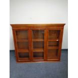 A reproduction glazed yew wood bookcase top