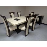 A contemporary simulated marble rectangular dining table together with matching three door