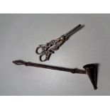 A silver candle snuffer together with a pair of silver plated grape scissors