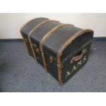 A wooden bound dome top trunk