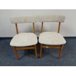 A pair of 20th century teak dining chairs