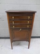 An Edwardian mahogany music cabinet