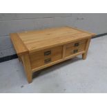 A contemporary oak low coffee table fitted four drawers