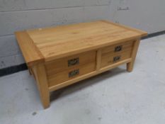 A contemporary oak low coffee table fitted four drawers