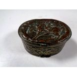 An antique embossed plated snuff box depicting figure on horseback