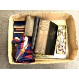 A box containing Masonic sash and apron, Masonic books, 19th century indenture in metal tin,