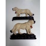 A pair of painted cast iron dog door stops