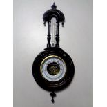 A carved ebonised barometer with enamel dial