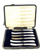 A set of six silver bladed and mother of pearl butter knives,