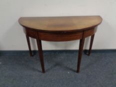 A 19th century mahogany demi lune table